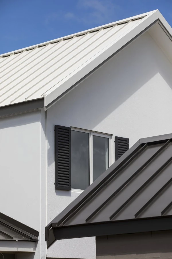 Modern architectural steel roofing on a residential home with clean white walls