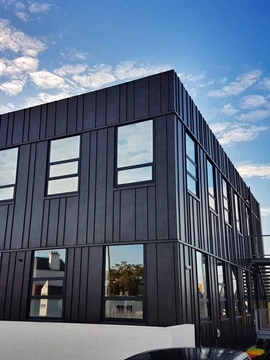 Modern building featuring steel cladding in Lux Corten Dark finish for a sleek and durable exterior.