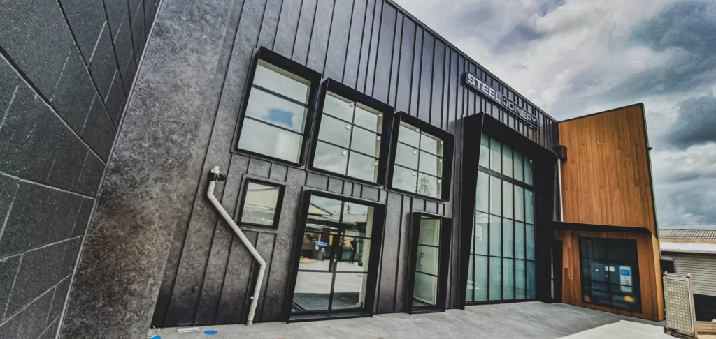 Commercial building featuring Lux Corten Dark steel cladding and large glass windows, offering a durable and modern exterior design.