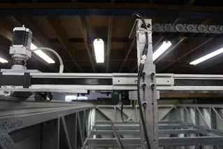 A laser scanner assembly mounted on a linear guide rail for high-precision measurement and data collection.