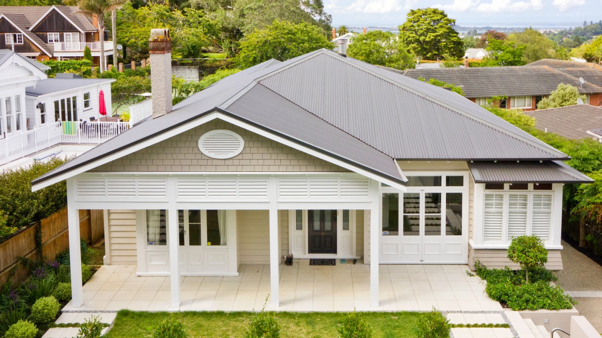 Coastal home with corrosion-resistant steel roofing by The Roofing Store.