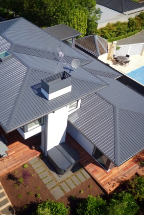 Residential project featuring TRS 5 long run roofing profile in Grey Friars color.