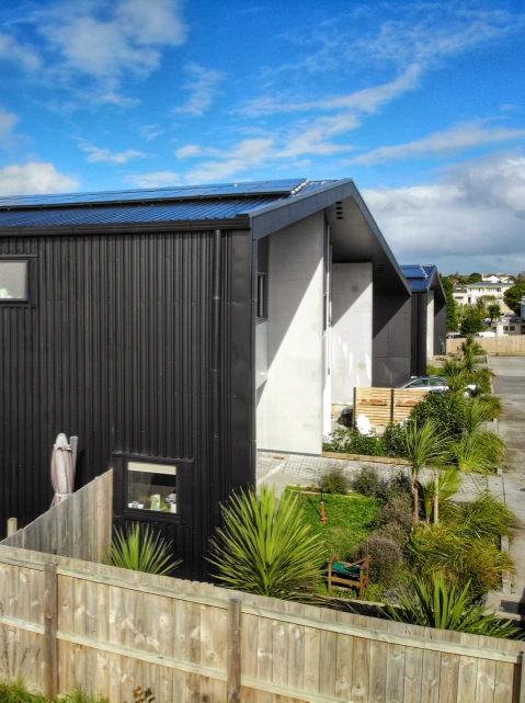 Residential project featuring TRS 9 long run roofing and cladding profile in Ebony and Scoria colors.