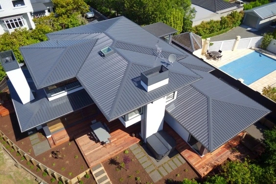 Aerial view of a modern residential home featuring TRS 5 roofing in Grey Friars color, showcasing a sleek and sophisticated design.