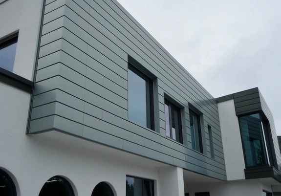 A commercial building featuring TRS Weather Board architectural steel cladding, showcasing a modern and clean exterior design.