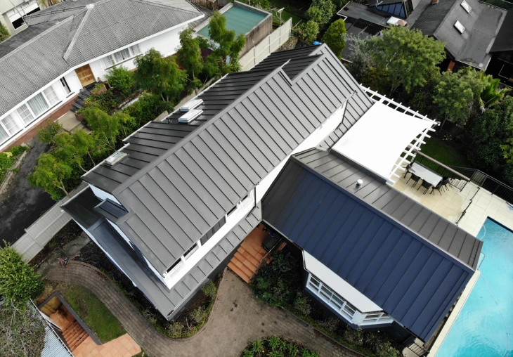 Aerial view of a modern residential building featuring TRS Super Seam roofing in a sleek and stylish design.