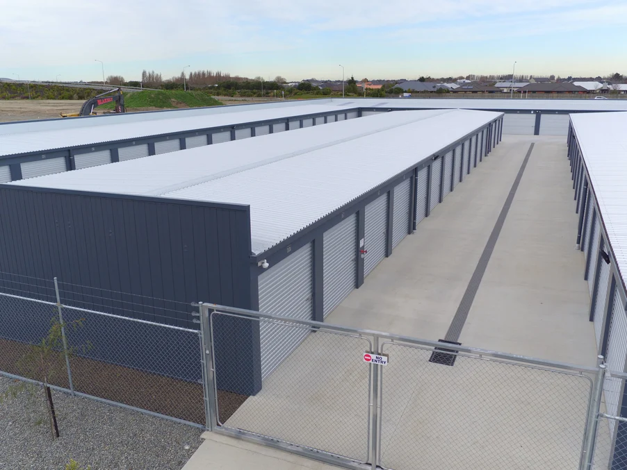 A secure storage facility with grey steel cladding and roofing.